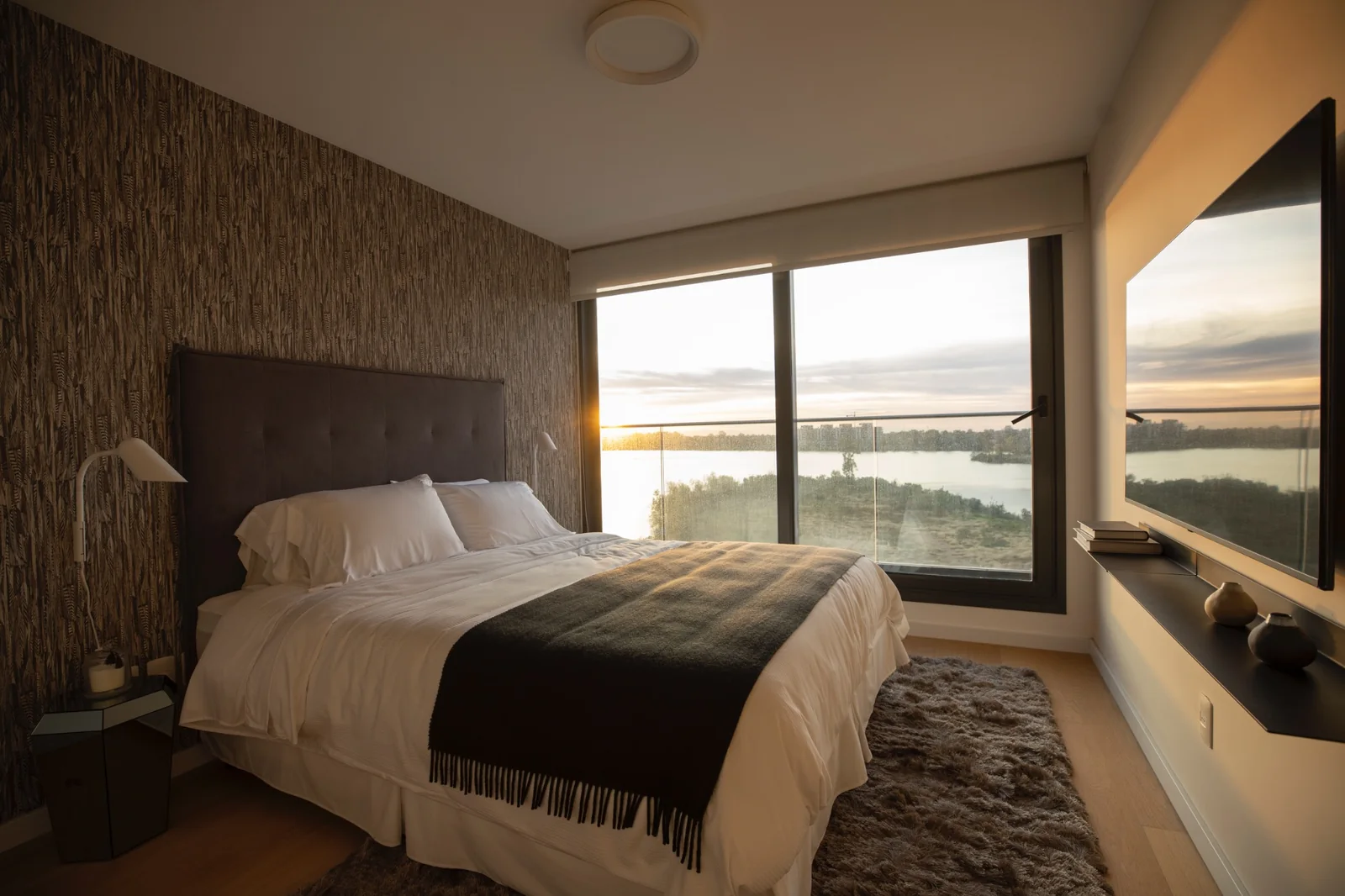 Dormitorio principal con vista al lago al atardecer